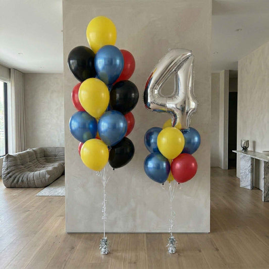 Colorful balloons with a large silver number '4' in a room.