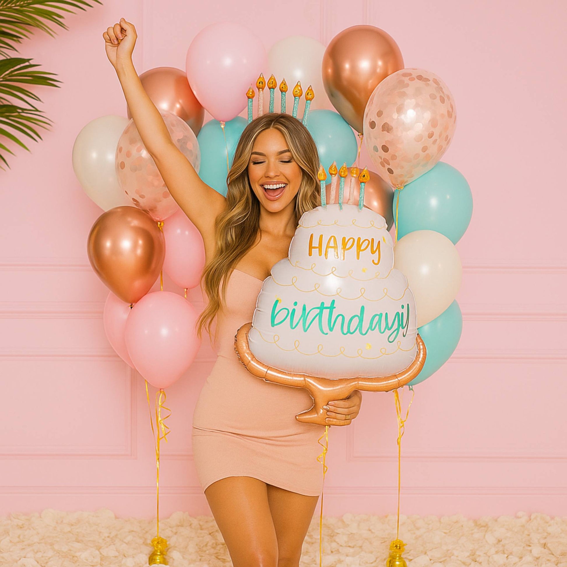 Woman holding a 'Happy Birthday' balloon with balloons in the background