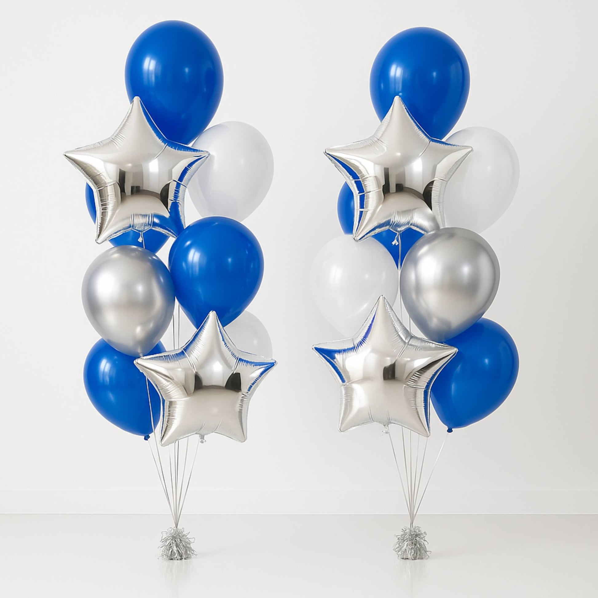 Two bouquets of balloons with blue, silver, and white balloons on a white background
