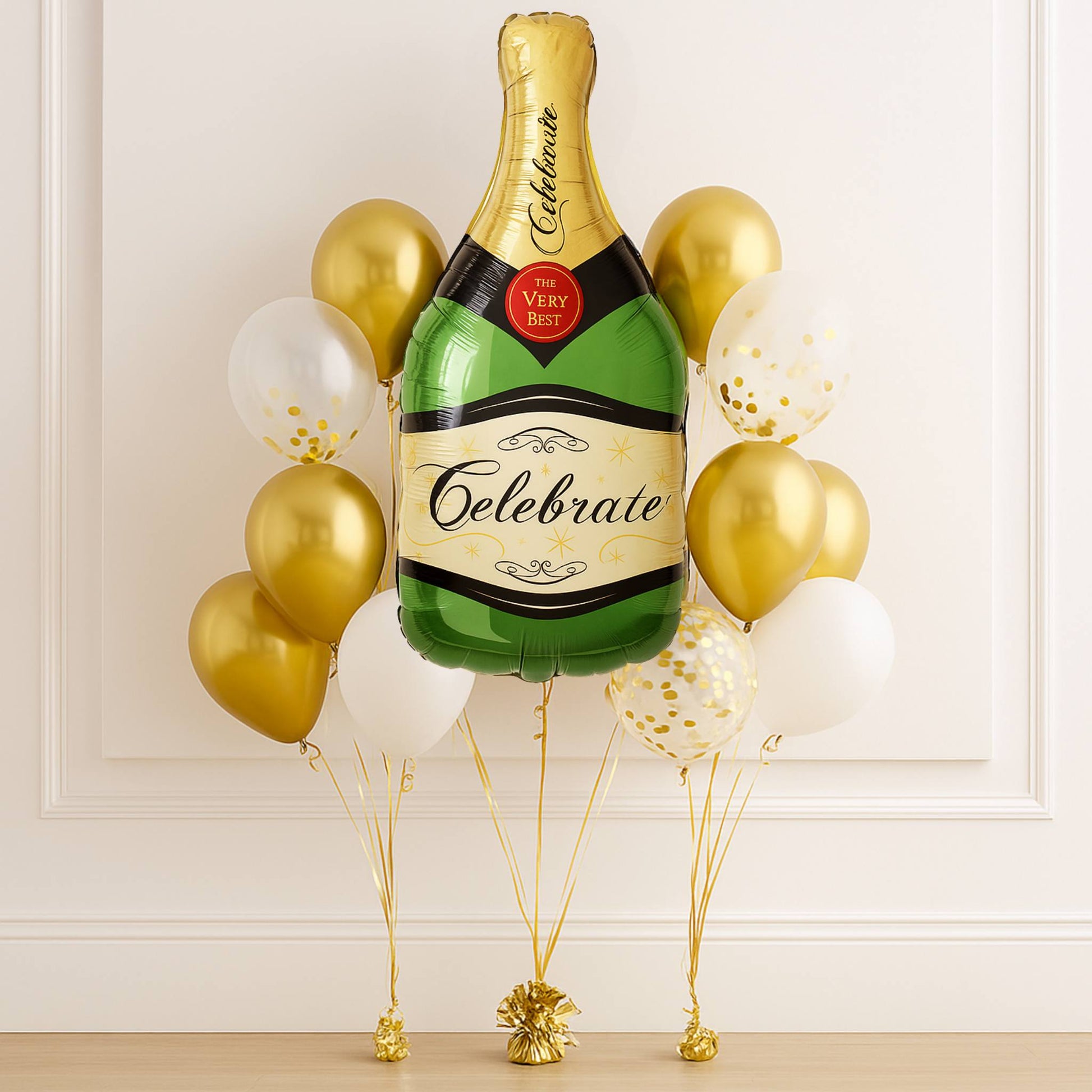 Balloons shaped like a champagne bottle with 'Celebrate' text against a white wall.