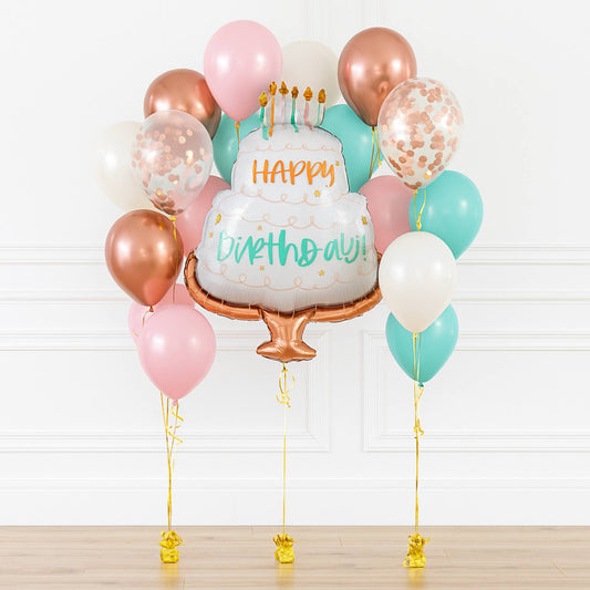 Balloon bouquet with a cake-shaped balloon featuring 'Happy Birthday' text on a white background.