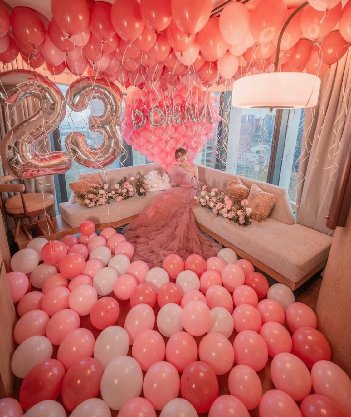 luxury balloon package woman sitting with balloons flowers and number balloon