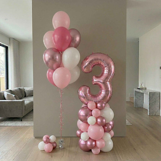 Balloon arrangement with a large number '3' in a living room setting