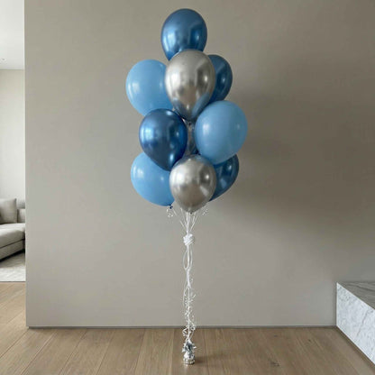 Bouquet of blue and silver balloons in a modern indoor setting