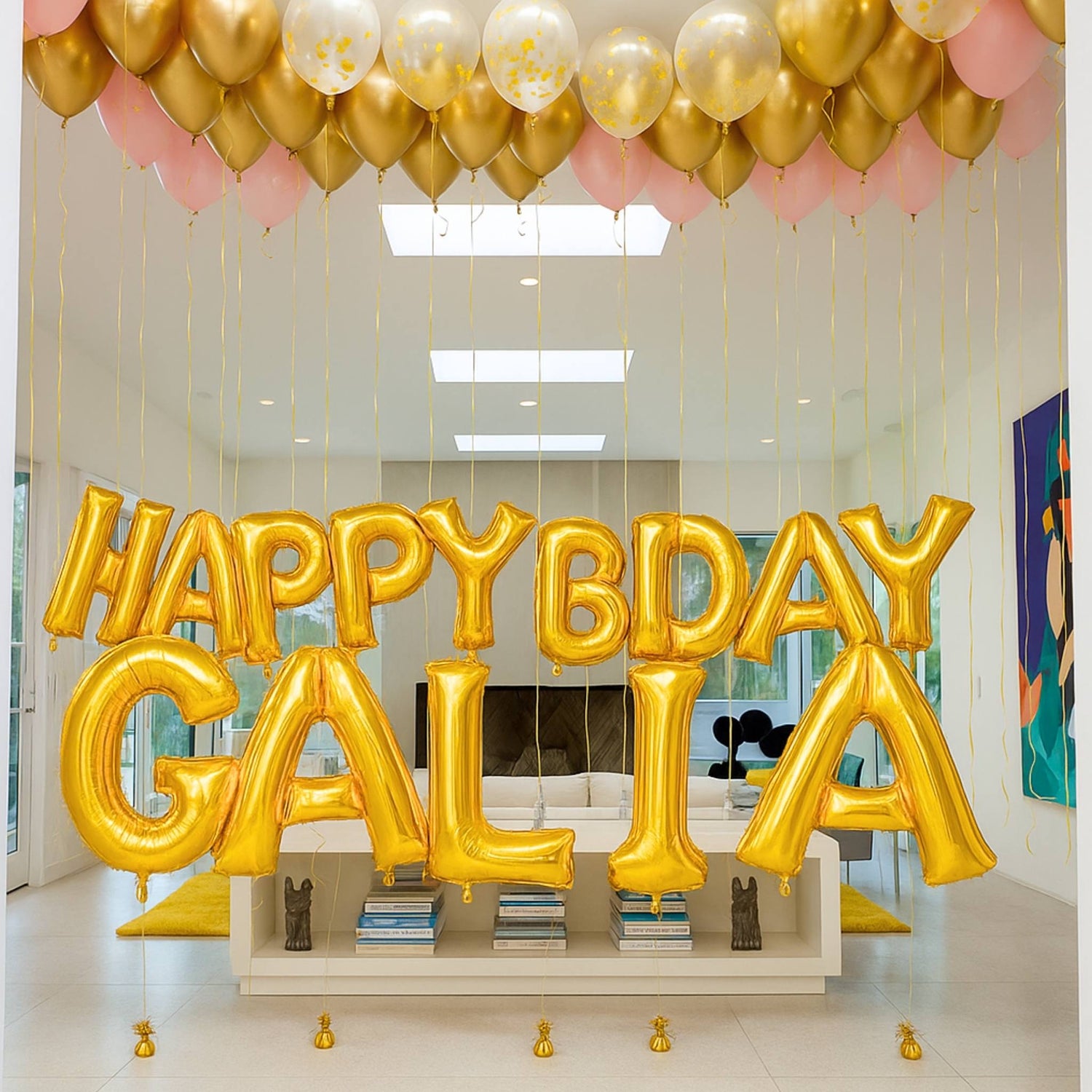 Gold 'HAPPY BDAY GALIA' balloons in a room with pink and gold balloons.