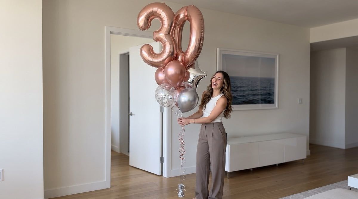 Load video: Luxury balloon bouquet number 26 displayed by a woman walking a runway, styled for an elegant celebration scene.