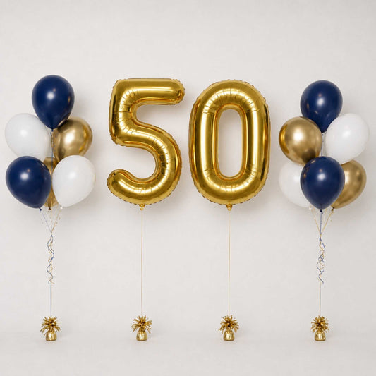 Gold foil balloon numbers 50 centered between two clusters of navy blue, metallic gold, and white balloons, with small gold confetti decorations at the bottom, set against a plain light background.