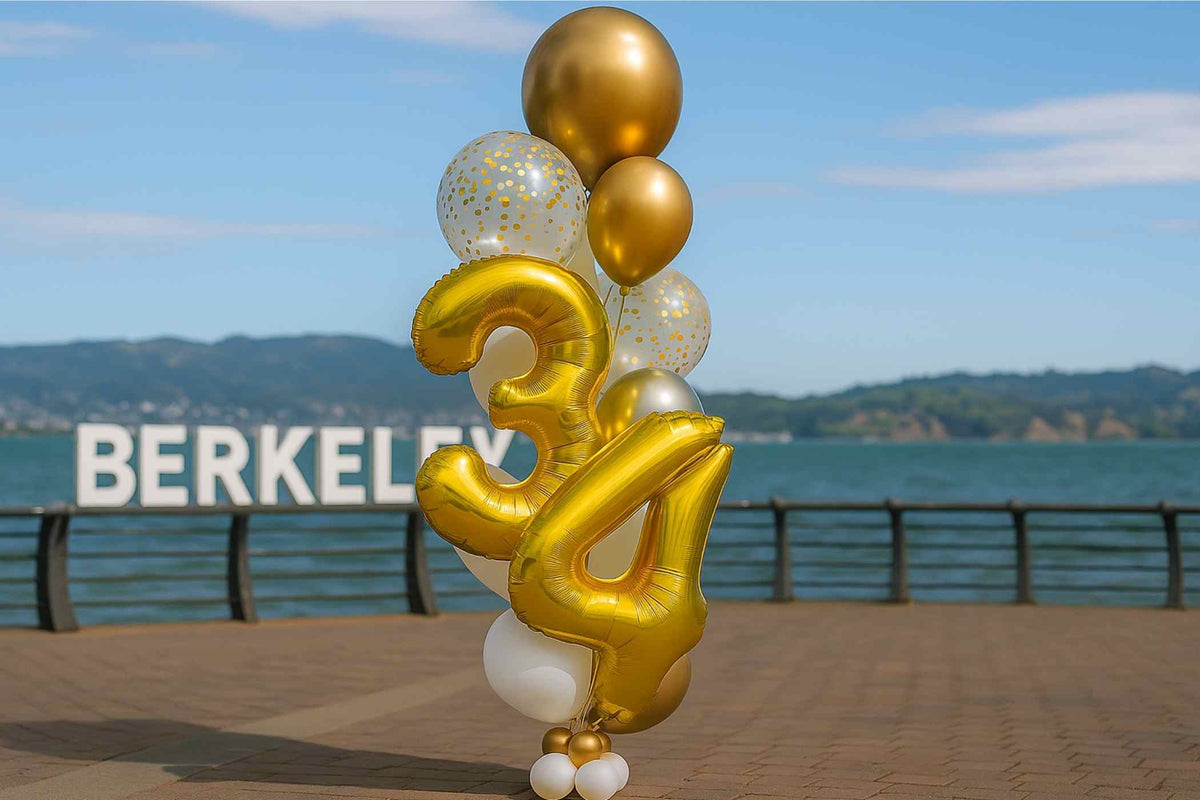 Gold and white balloons with numbers '34' on a pier with 'BERKELEY' sign in the background.
