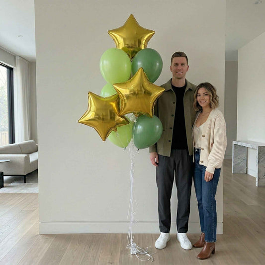 Man and woman standing indoors with green and gold balloons with silver weight large house