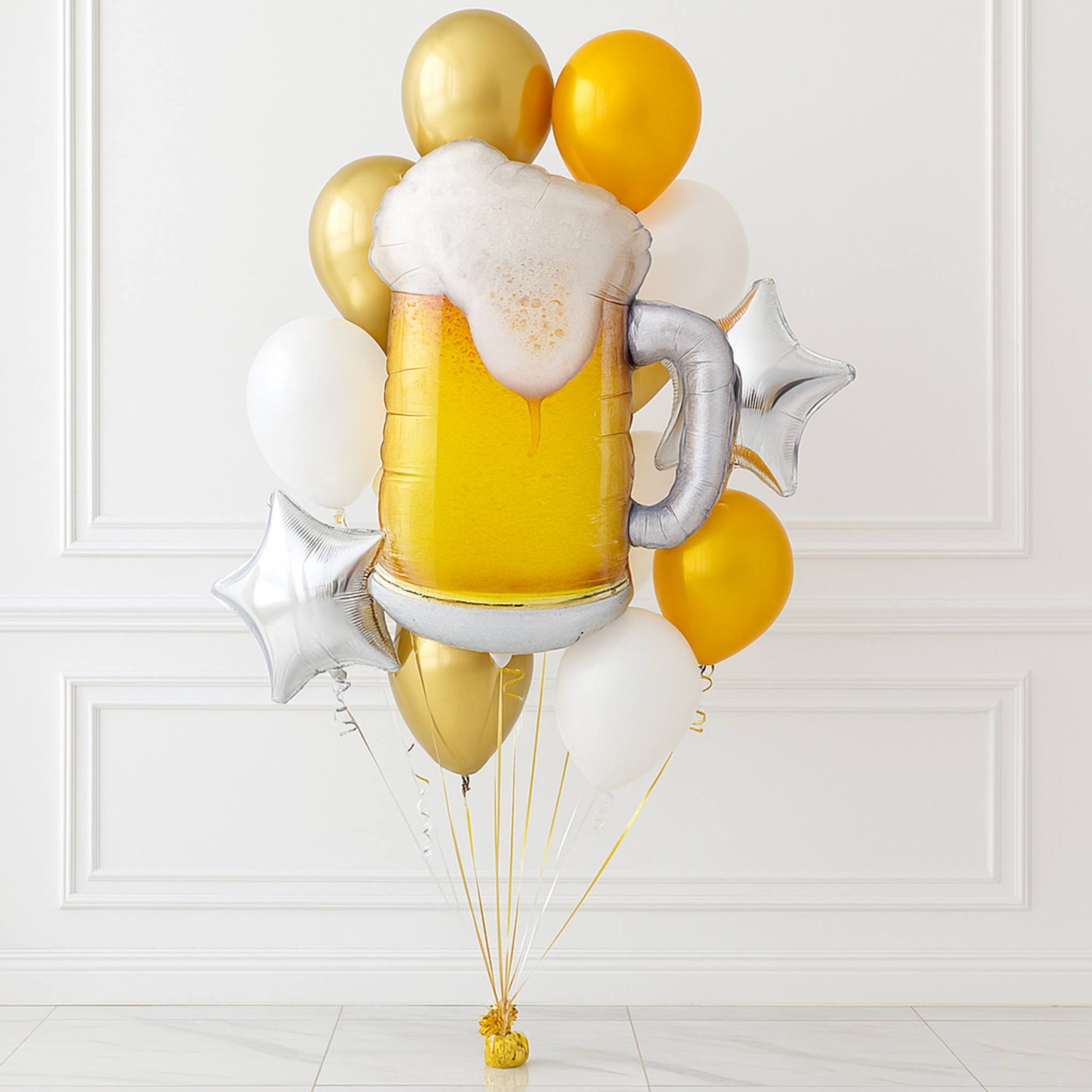Balloon bouquet shaped like a beer mug with gold and yellow balloons on a white background