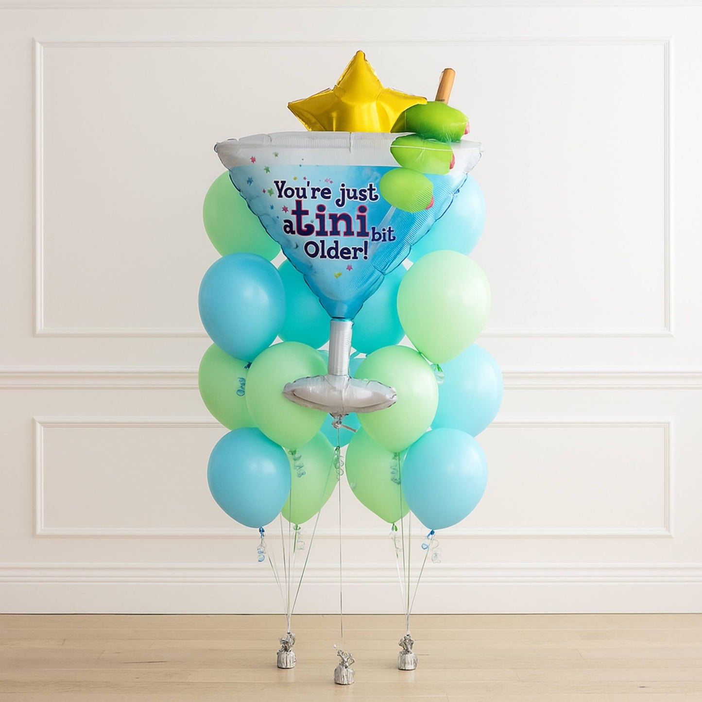 A tiny bit older birthday helium green blue balloon bouquet