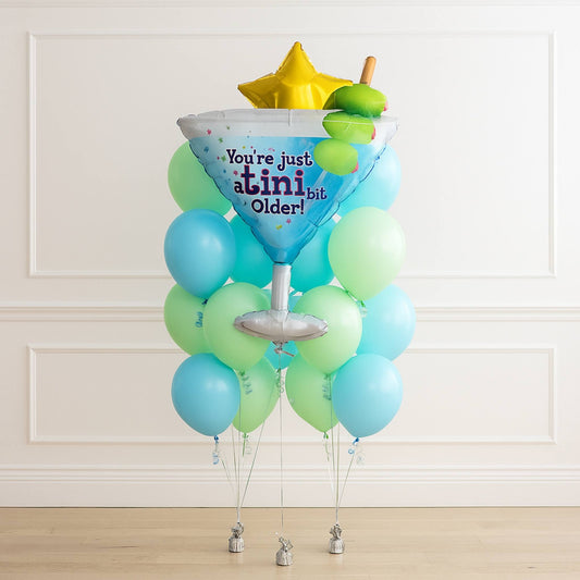 A tiny bit older birthday helium green blue balloon bouquet