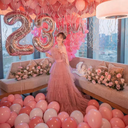 luxury pink balloon and flower package with woman smiling