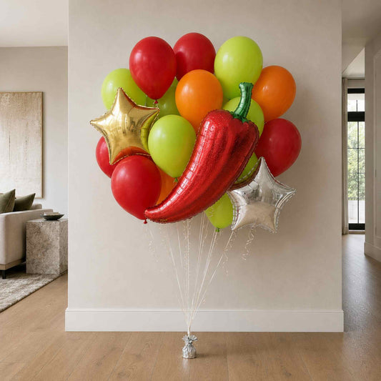 Colorful balloon bouquet with a red chili pepper balloon in a room.