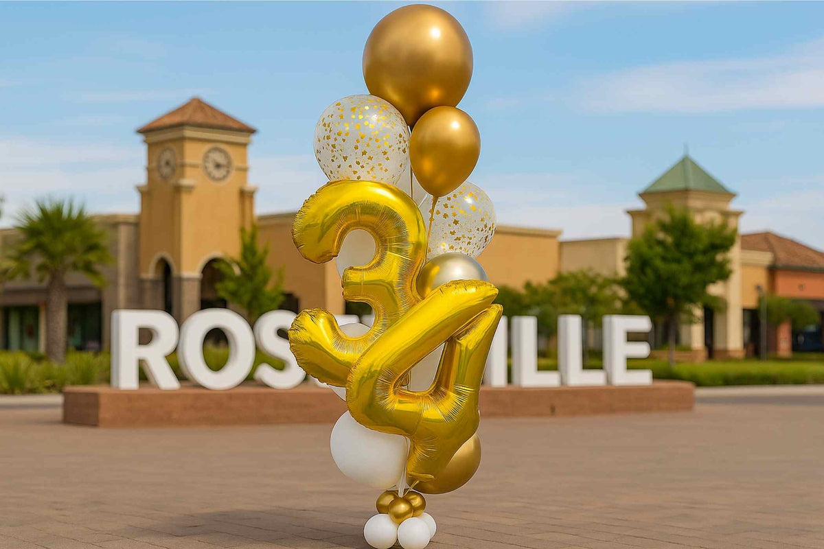 Gold and white balloons with numbers '34' in front of a building with 'Roswell' sign.